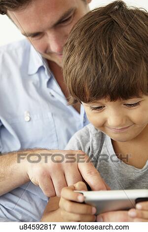 Stock Photo - Father and son with cellphone. Fotosearch