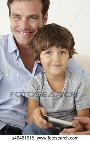 Stock Photography - Father and son with cellphone. Fotosearch