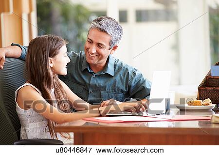 Father And Teenage Daughter Looking At Laptop Together View Large Photo Image Stock Photo - Father And Teenage Daughter Looking At Laptop Together. Fotosearch