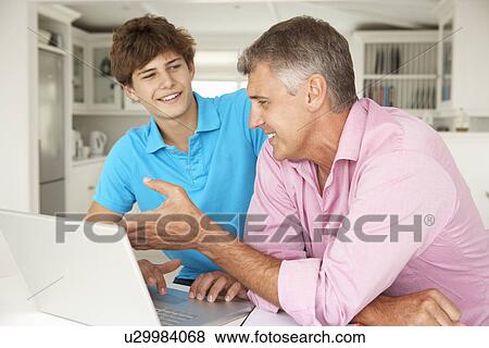 Father and teenage son using laptop View Large Photo Image Stock Photo - Father and teenage son using laptop. Fotosearch