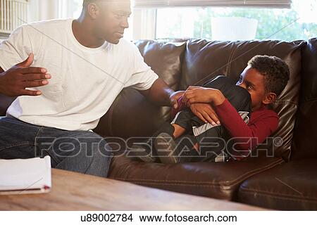 Picture - Father Being Physically Abusive Towards Son At Home. Fotosearch