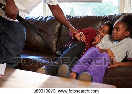 Stock Image - Father Being Physically Abusive Towards Children At Home. Fotosearch
