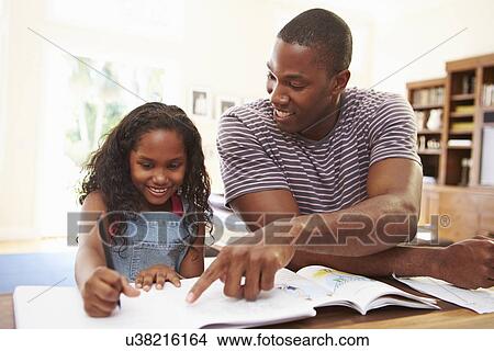 Picture - Father Helping Daughter With Homework. Fotosearch