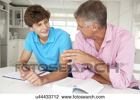 Father helping teenage son with homework View Large Photo Image Stock Image - Father helping teenage son with homework. Fotosearch