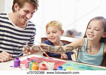 Stock Photo - Father Painting Picture With Children At Home. Fotosearch