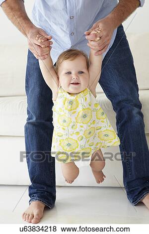 Father playing with baby daughter at home View Large Photo Image Stock Photo - Father playing with baby daughter at home. Fotosearch