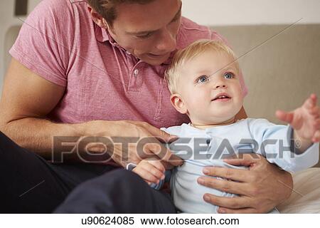 Stock Photography - Father Playing With Young Son Indoors. Fotosearch