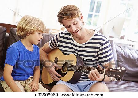 Stock Photo - Father Teaching Son To Play Guitar. Fotosearch