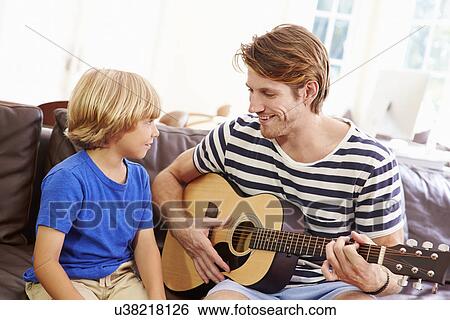 Father Teaching Son To Play Guitar View Large Photo Image Stock Photograph - Father Teaching Son To Play Guitar. Fotosearch