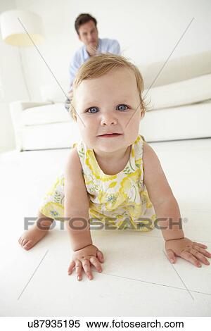 Father watching baby daughter crawl View Large Photo Image Stock Photography - Father watching baby daughter crawl. Fotosearch