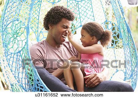 Father With Daughter Relaxing On Outdoor Garden Swing Seat View Large Photo Image Stock Image - Father With Daughter Relaxing On Outdoor Garden Swing Seat. Fotosearch