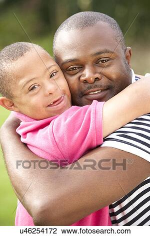 Stock Image - Father with Downs Syndrome son. Fotosearch