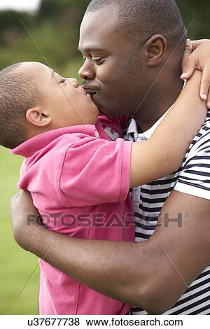 Stock Photo - Father with Downs Syndrome son. Fotosearch
