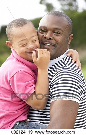 Stock Photo - Father with Downs Syndrome son. Fotosearch