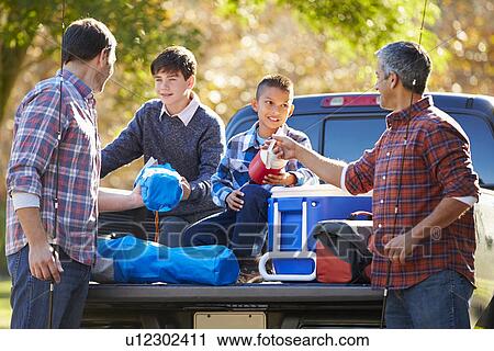 Fathers With Sons Unpacking Truck On Camping Holiday View Large Photo Image Stock Image - Fathers With Sons Unpacking Truck On Camping Holiday. Fotosearch