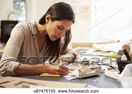 Stock Photography - Female Architect Making Model In Office. Fotosearch