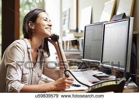 Stock Photo - Female Architect Working At Desk On Computer. Fotosearch