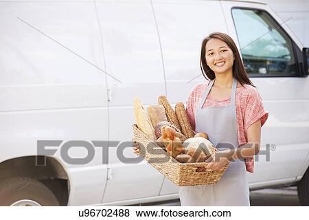 Female Baker Delivering Bread Standing In Front Of Van View Large Photo Image Stock Photo - Female Baker Delivering Bread Standing In Front Of Van. Fotosearch