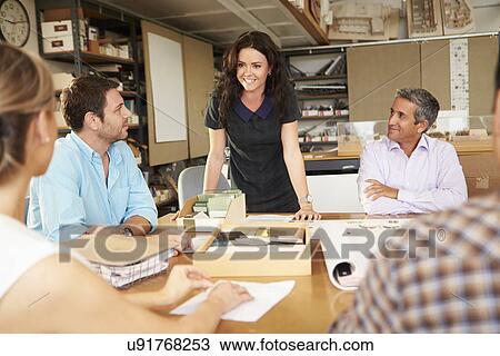 Female Boss Leading Meeting Of Architects Sitting At Table View Large Photo Image Stock Image - Female Boss Leading Meeting Of Architects Sitting At Table. Fotosearch
