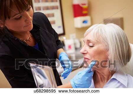 Female Client Looking In Mirror After Botox Treatment View Large Photo Image Stock Photography - Female Client Looking In Mirror After Botox Treatment. Fotosearch