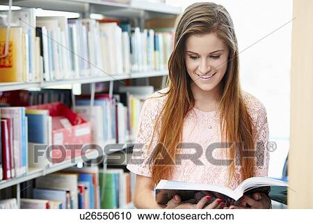 Stock Image - Female College Student Studying In Library. Fotosearch