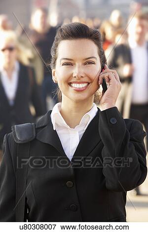 Stock Photo - Female commuter talking on phone. Fotosearch