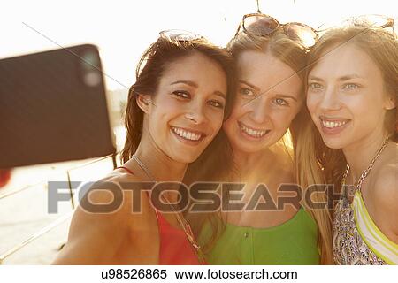 Female Friends On Holiday Together Taking Selfie View Large Photo Image Stock Photography - Female Friends On Holiday Together Taking Selfie . Fotosearch
