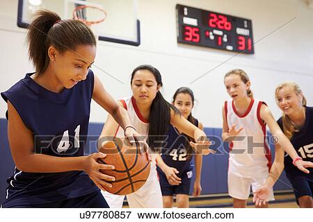 Stock Photo - Female High School Basketball Team Playing Game. Fotosearch