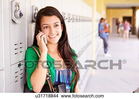 Picture - Female High School Student By Lockers Using Mobile Phone. Fotosearch