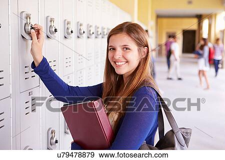 Stock Photo - Female High School Student Opening Locker. Fotosearch