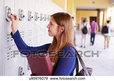 Stock Photo - Female High School Student Opening Locker. Fotosearch