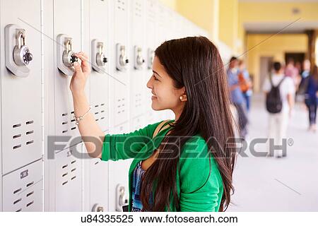 Stock Photography - Female High School Student Opening Locker. Fotosearch