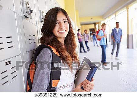 Stock Photo - Female High School Student Standing By Lockers. Fotosearch