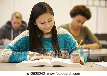Female High School Student Studying At Desk In Classroom View Large Photo Image Stock Image - Female High School Student Studying At Desk In Classroom. Fotosearch