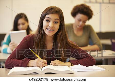 Female High School Student Studying At Desk In Classroom View Large Photo Image Stock Photo - Female High School Student Studying At Desk In Classroom. Fotosearch