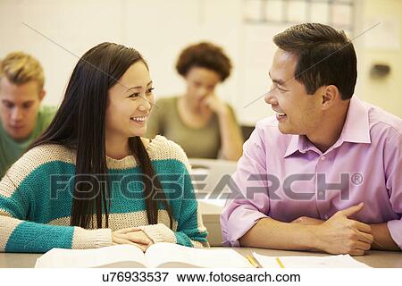 Female High School Student With Teacher Studying At Desk View Large Photo Image Stock Photo - Female High School Student With Teacher Studying At Desk. Fotosearch