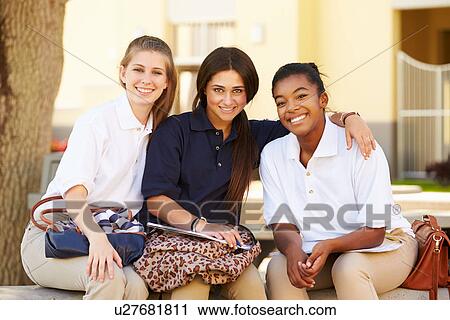 Stock Image - Female High School Students Hanging Out On School Campus . Fotosearch
