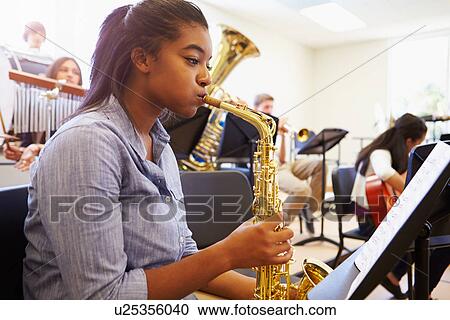 Female Pupil Playing Saxophone In High School Orchestra View Large Photo Image Stock Image - Female Pupil Playing Saxophone In High School Orchestra. Fotosearch