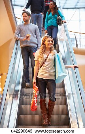 Female Shopper On Escalator In Shopping Mall View Large Photo Image Stock Image - Female Shopper On Escalator In Shopping Mall. Fotosearch