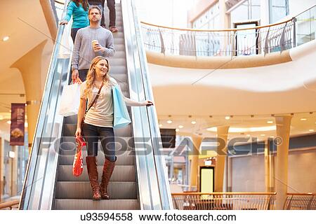 Female Shopper On Escalator In Shopping Mall View Large Photo Image Stock Photo - Female Shopper On Escalator In Shopping Mall. Fotosearch