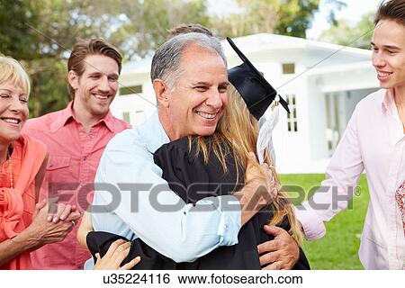 Stock Photograph - Female Student And Family Celebrating Graduation. Fotosearch