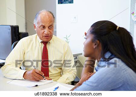 Female Student Talking To High School Counselor View Large Photo Image Stock Photo - Female Student Talking To High School Counselor. Fotosearch