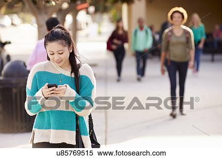 Female Student Walking To High School Using Mobile Phone View Large Photo Image Stock Photography - Female Student Walking To High School Using Mobile Phone. Fotosearch