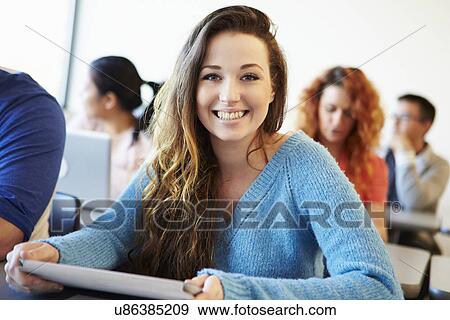 Stock Photo - Female University Student Using Digital Tablet In Classroom. Fotosearch
