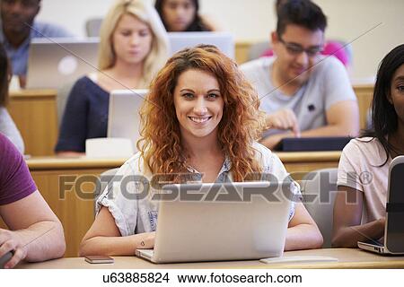 Picture - Female University Student Using Laptop In Lecture. Fotosearch