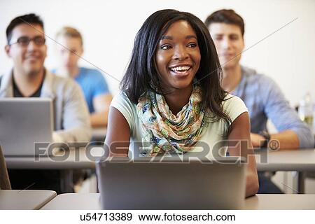 Female University Student Using Laptop In Classroom View Large Photo Image Stock Photo - Female University Student Using Laptop In Classroom. Fotosearch