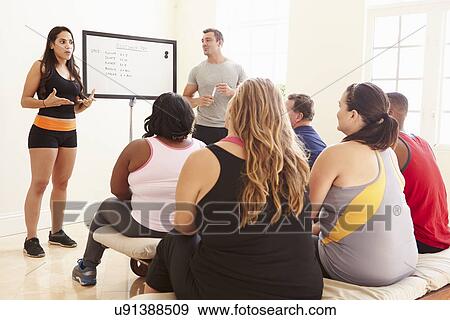 Stock Photo - Fitness Instructor Addressing Overweight People At Diet Club. Fotosearch