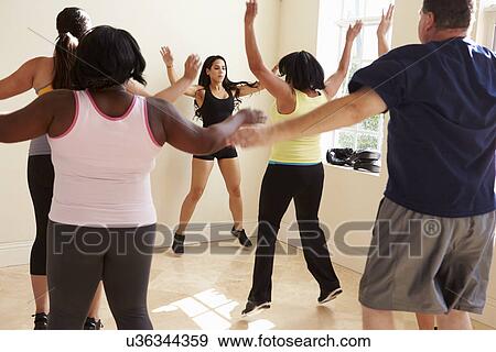 Fitness Instructor In Exercise Class For Overweight People View Large Photo Image Stock Photo - Fitness Instructor In Exercise Class For Overweight People . Fotosearch