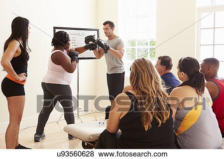 Stock Photo - Fitness Instructor In Exercise Class For Overweight People . Fotosearch