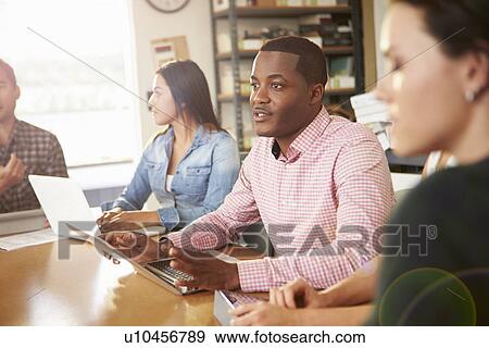 Four Architects Sitting Around Table Having Meeting View Large Photo Image Stock Photo - Four Architects Sitting Around Table Having Meeting. Fotosearch